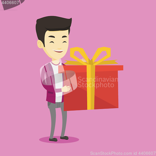 Image of Joyful asian man holding box with gift.