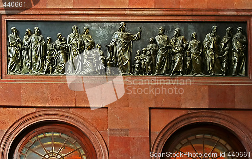 Image of metalic stamping with Christ's preach in cathedral