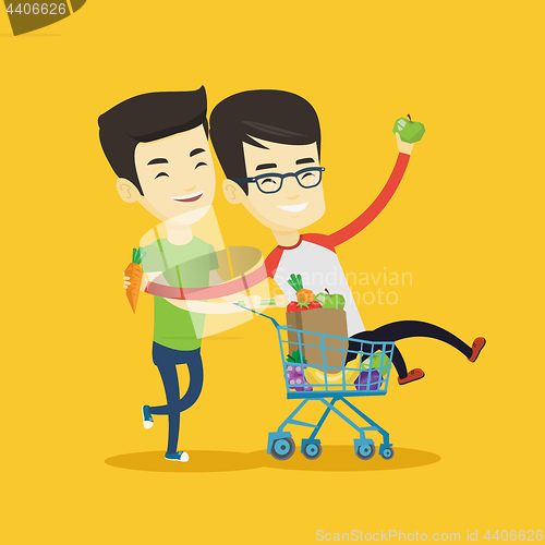 Image of Couple of friends riding by shopping trolley.