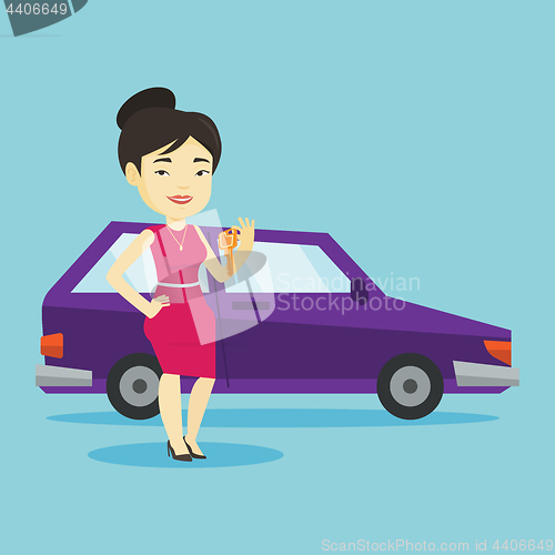 Image of Woman holding keys to her new car.