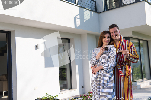 Image of Young beautiful couple in bathrobes