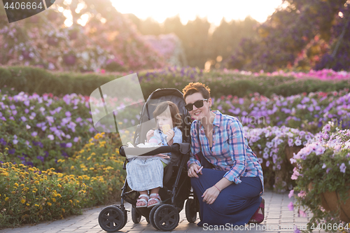 Image of mother and daughter in flower garden