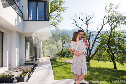 Image of Young beautiful couple in bathrobes