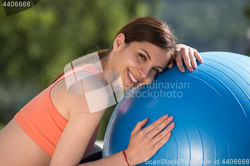 Image of woman doing exercise with pilates ball