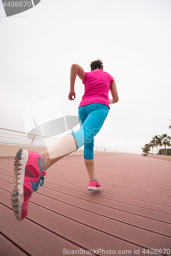 Image of woman busy running on the promenade