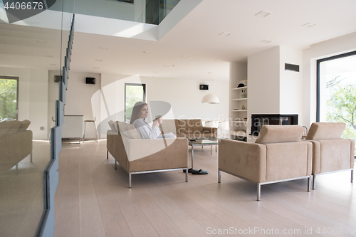 Image of young woman in a bathrobe enjoying morning coffee