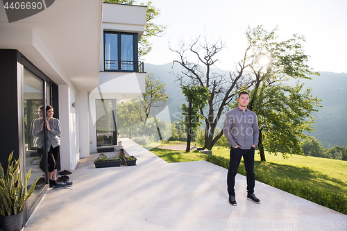 Image of man in front of his luxury home villa