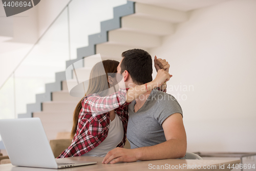 Image of happy young couple buying online