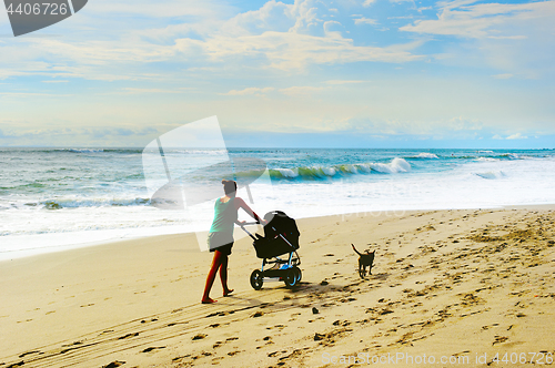 Image of Beach walking with baby carriage 