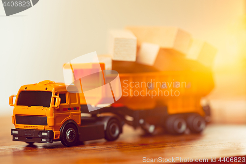 Image of The toy car and building truck on wooden table