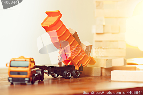 Image of The toy car and building truck on wooden table