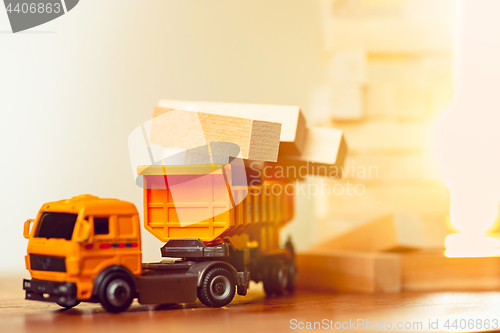 Image of The toy car and building truck on wooden table