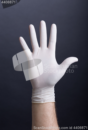 Image of Male hand in latex glove
