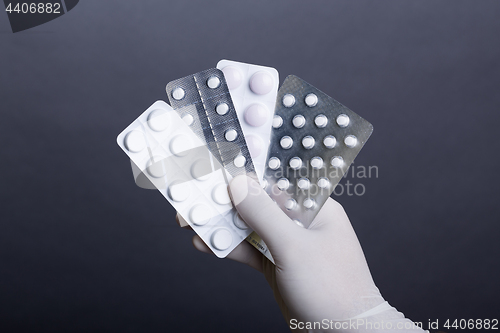 Image of Hand with pills blisters