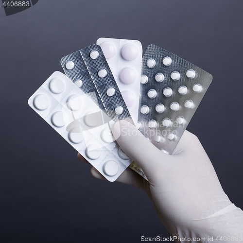Image of Hand with pills blisters