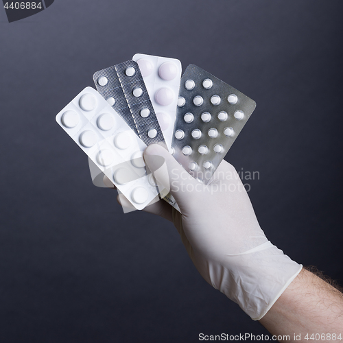 Image of Hand with pills blisters