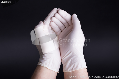 Image of Male hands in latex gloves