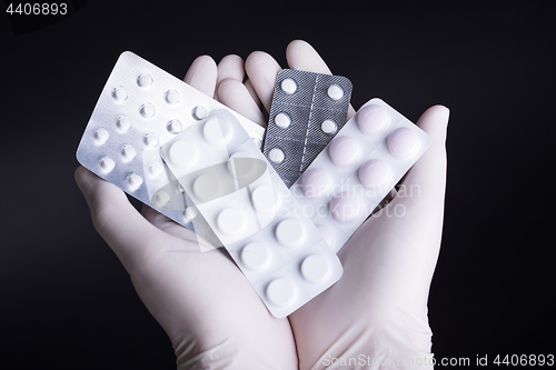 Image of Hand with pills blisters