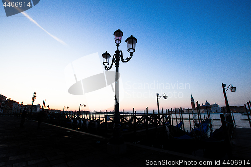 Image of Street lamp silhouette in Venice, Italy at sunrise