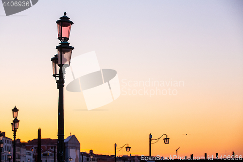 Image of Street lamp silhouette in Venice, Italy at sunrise