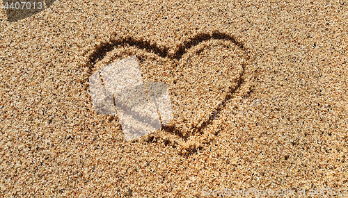 Image of Abstract heart drawing in sand 