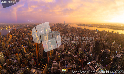 Image of New York City skyline with Manhattan skyscrapers at dramatic stormy sunset, USA.