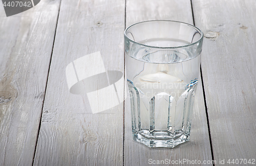 Image of Glass of water on white wooden table