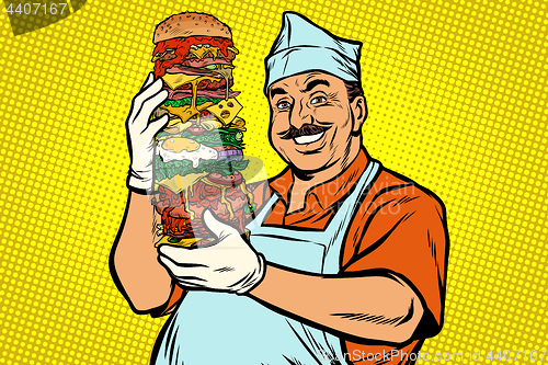 Image of smiling Oriental street food chef. big Burger