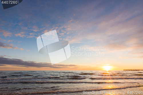 Image of Cloudy sky above the sea at sunset