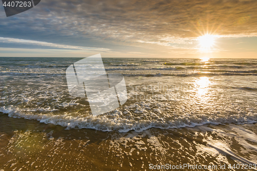 Image of Sea surf at sunset