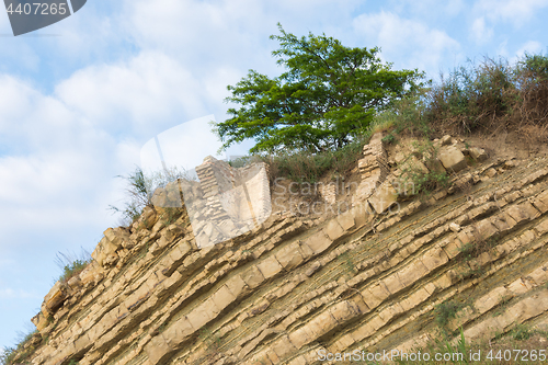 Image of The remains of a ruined building on top of a rock