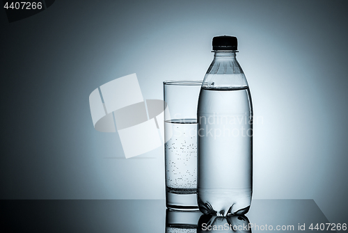 Image of Plastic bottle and glass with water