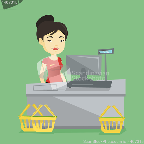 Image of Cashier standing at the checkout in supermarket.