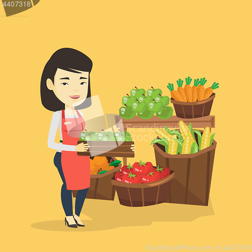 Image of Supermarket worker with box full of apples.