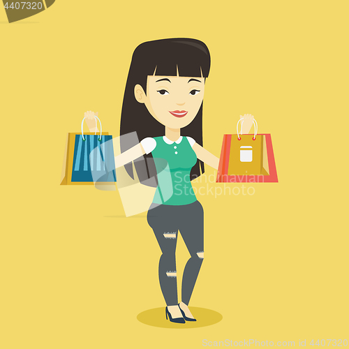 Image of Happy woman holding shopping bags.