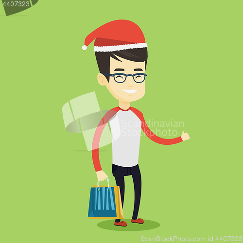 Image of Man in santa hat shopping for christmas gifts.