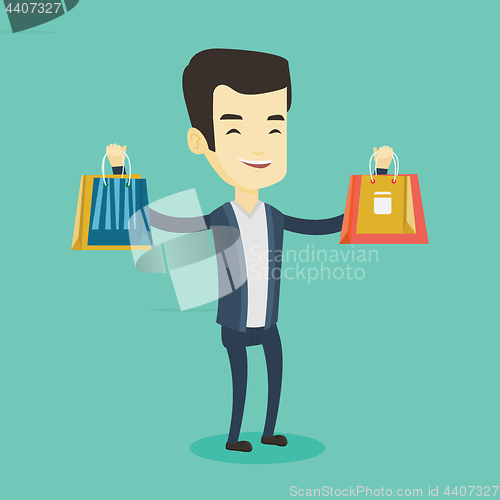 Image of Happy man holding shopping bags.