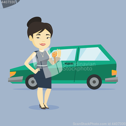 Image of Woman holding keys to her new car.