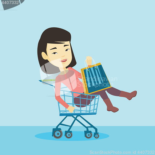 Image of Happy woman riding by shopping trolley.