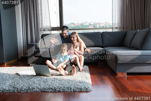 Image of Family Playing Together with laptop computer