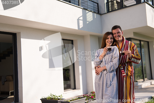 Image of Young beautiful couple in bathrobes