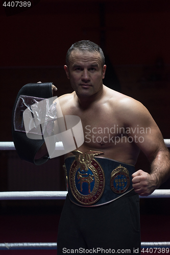 Image of kick boxer with his championship belt