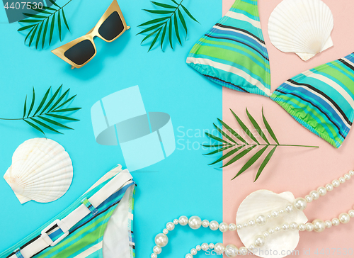 Image of Summer fashion flat lay on blue and pink background