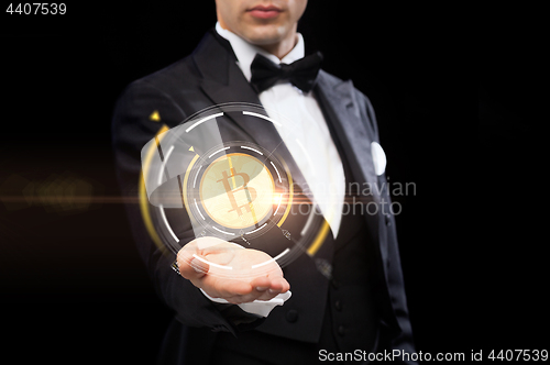 Image of close up of magician with bitcoin symbol