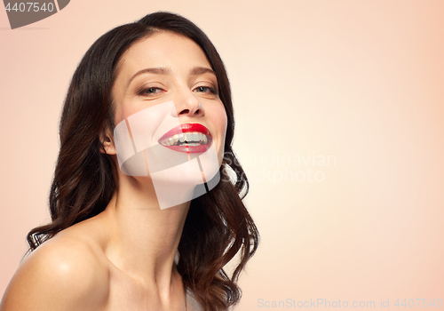 Image of beautiful smiling young woman with red lipstick