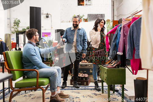 Image of friends choosing clothes at vintage clothing store