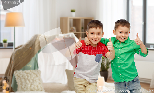 Image of happy smiling little boys showing thumbs up