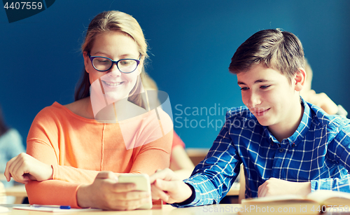 Image of students with smartphone texting at school