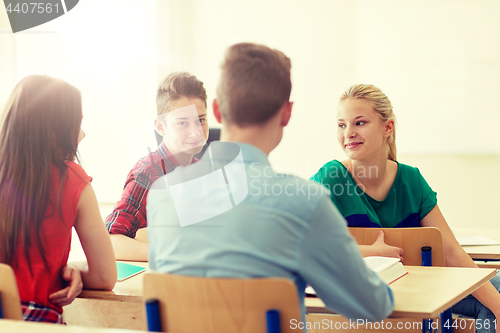 Image of group of students with notebooks at school lesson