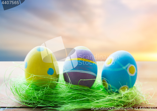 Image of close up of colored easter eggs and grass